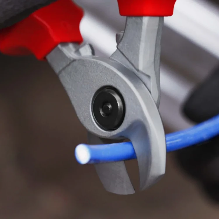 Nożyce do kabli KNIPEX 95 16 165 – szczegółowe ujęcie profilowanych szczęk i skręcanego przegubu podczas cięcia przewodu.
