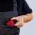 KNIPEX BiX CT56 90 22 10 V01 – poręczny obcinak do peszli i rur plastikowych, przechowywany w kieszeni odzieży roboczej instalatora.